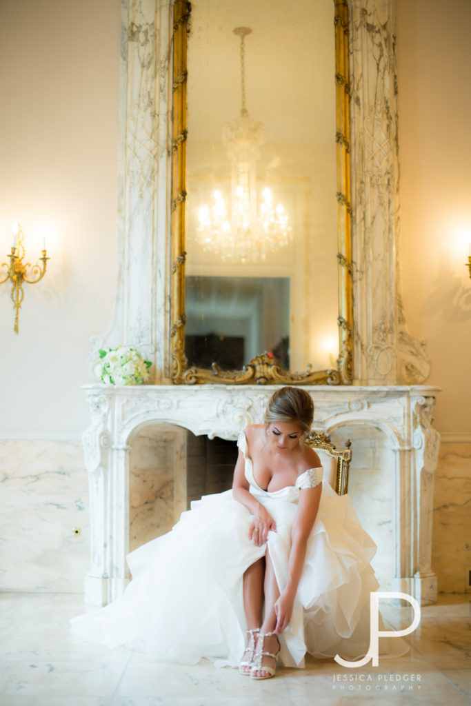 Bride putting on shoes at Chateau Cocomar