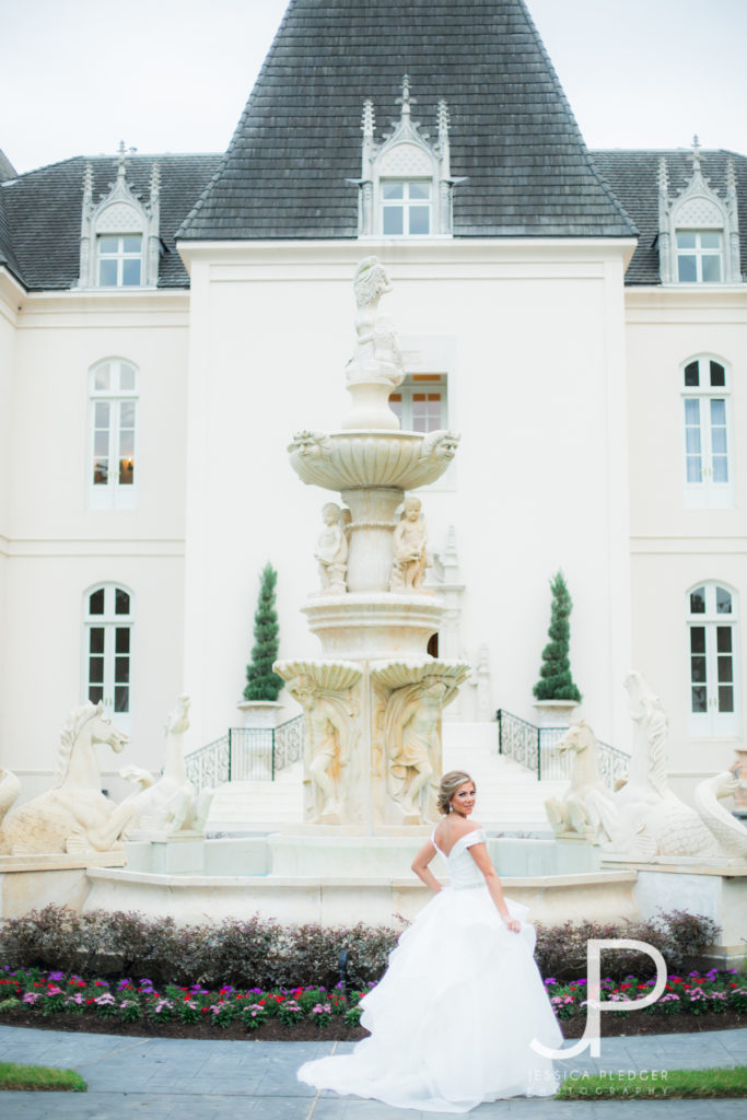 Bride in front of fountain at Chateau Cocomar