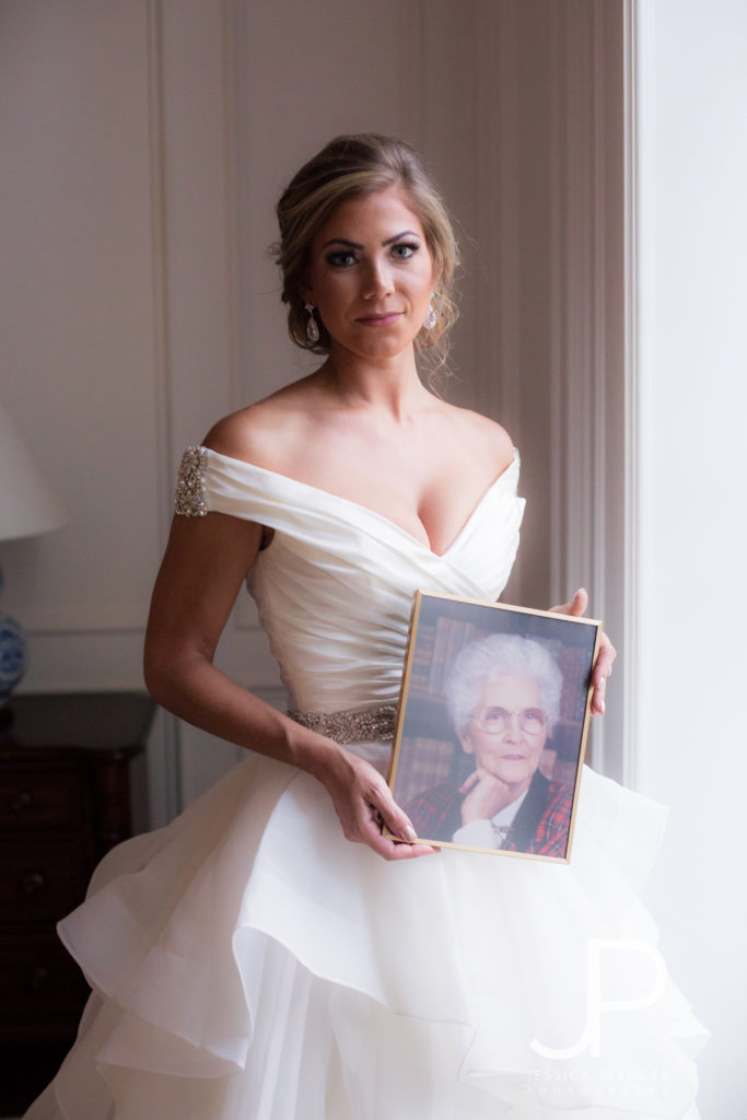Bride holding grandmother's photo