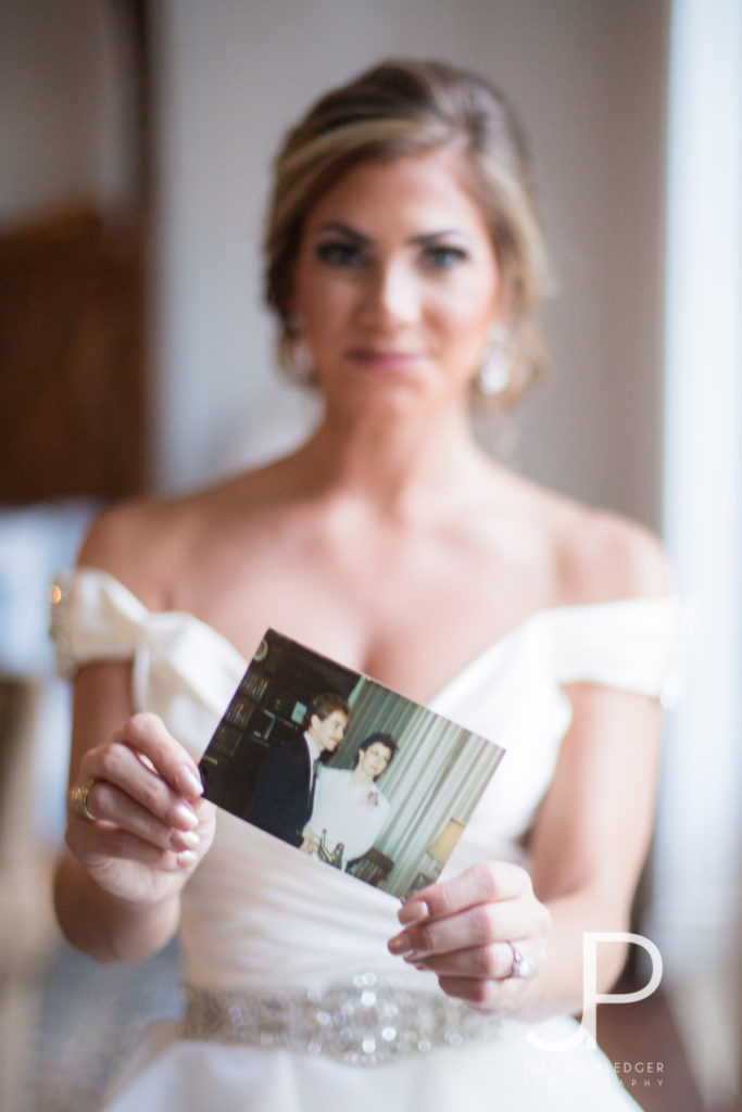 Bride holding parent's wedding photo