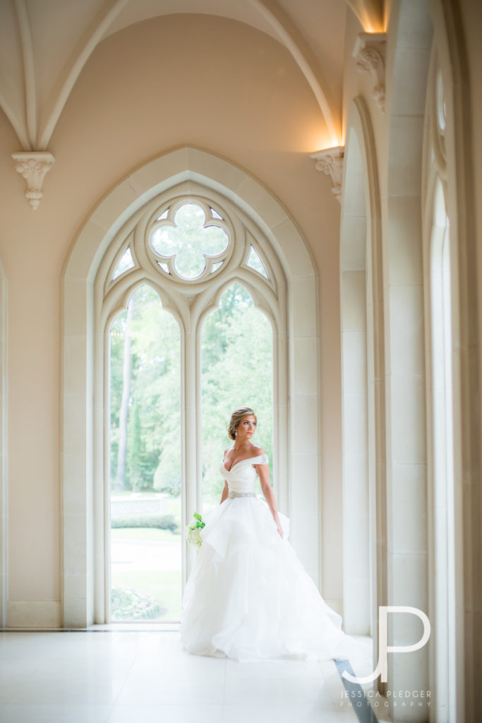 Bride looking out window at Chateau Cocomar